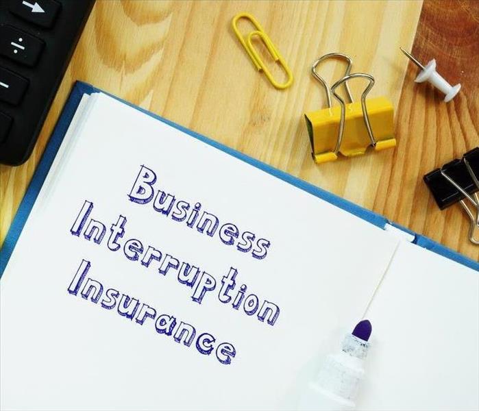 Financial Concept Meaning Business Interruption Insurance With Signature On Paper.
