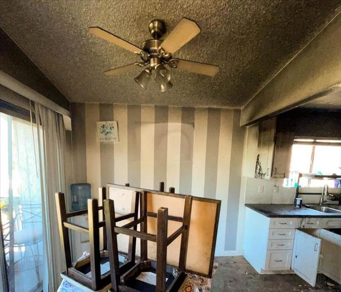 Fire damage in the dining room and kitchen of a home.